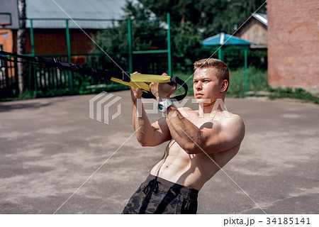 Male athlete close-up, trains nature the city 34185141