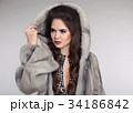 Siberian woman in mink fur coat over studio gray 34186842