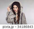 beautiful woman in fur coat. fashionable studio 34186843