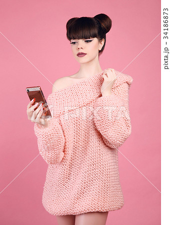 Brunette holding mobile phone. Fashion studio teen Brunette holding mobile phone. Fashion studio teen 34186873