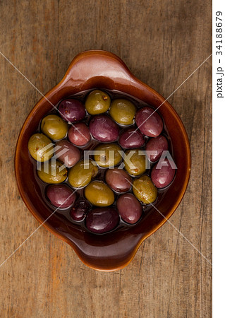 Olives with vegetable and spice by oil in bowl on table Olives with vegetable and spice by oil in bowl on table 34188679