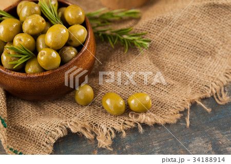 Close up of brown olives in wooden container Close up of brown olives in wooden container 34188914