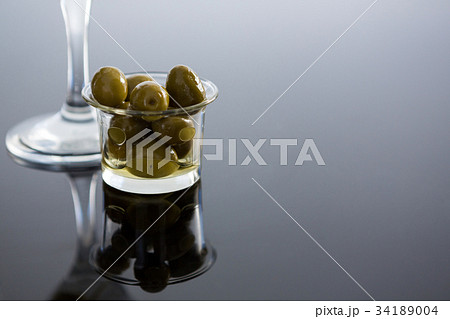 Pickled olives with herbs and chili in bowl on table Pickled olives with herbs and chili in bowl on table 34189004