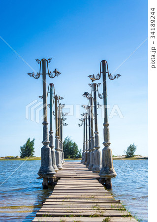 Wood pier and the light posts in pond 34189244