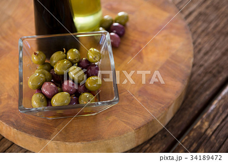 Cocktail martini with olives on table 34189472