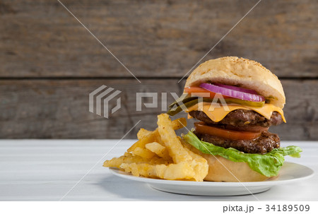 Hamburger, french fries and cold drink on table Hamburger, french fries and cold drink on table 34189509