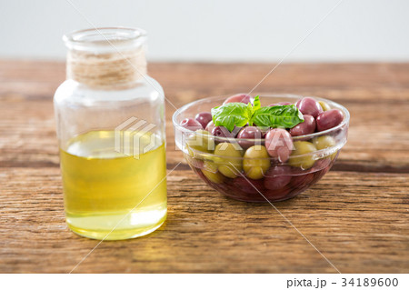 Close-up of marinated olives with glass of wine Close-up of marinated olives with glass of wine 34189600
