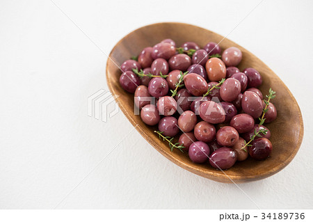 Pickled olives, rosemary with lemon and red chilies on table 34189736