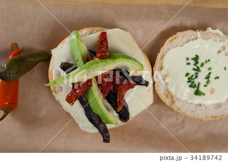 Hamburger, french fries and tomato sauce on chopping board 34189742