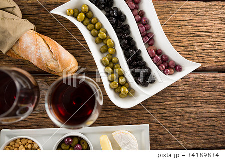 Close-up of marinated olives with olive oil and balsamic vinegar bottle 34189834