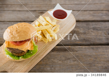 Close-up of hamburger and french fries in take way bag Close-up of hamburger and french fries in take way bag 34189846