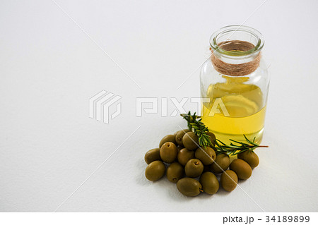 Close-up of marinated olives with glasses of wine 34189899