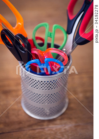 Overhead view of office supplies with camera and artificial tulip flowers Overhead view of office supplies with camera and artificial tulip flowers 34192278