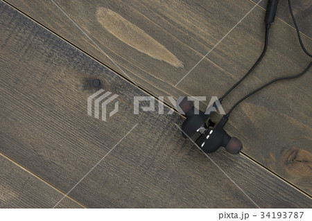 earphones on wood desk with copy space. earphones on wood desk with copy space. 34193787