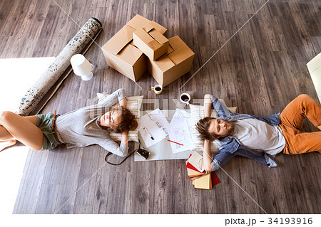 Young couple moving in new house, drinking coffee. Young couple moving in new house, drinking coffee. 34193916