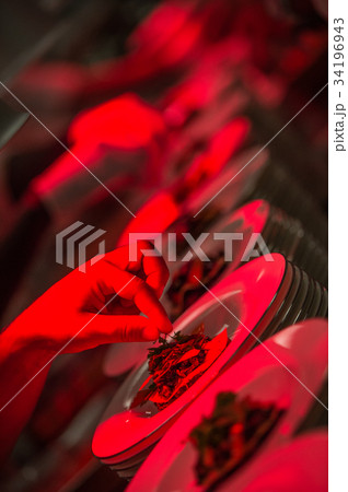 Male chef garnishing his dish, ready to serve 34196943