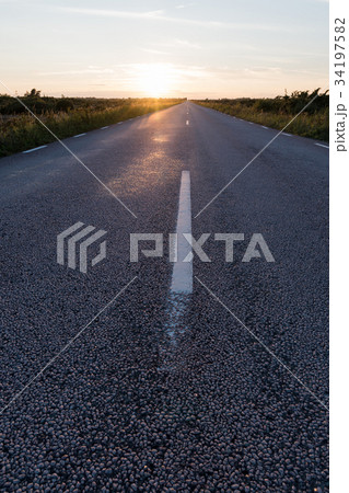 Sunlit asphalt road from low perspective 34197582