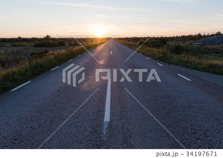 Straight country road in an open landscape 34197671