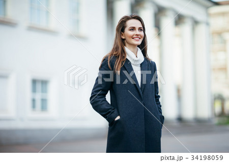 Laughing beautiful woman in city street 34198059