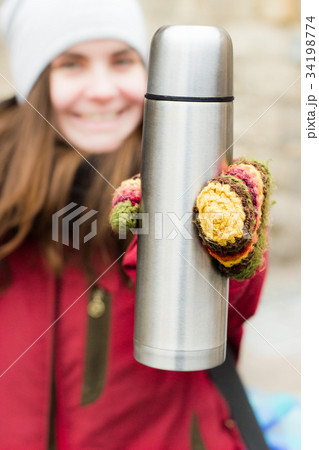 Young woman with thermos Young woman with thermos 34198774