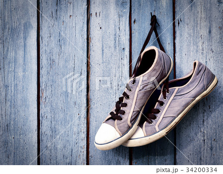 pair of old man's dirty blue sneakers 34200334