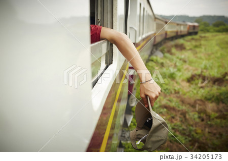 A hat is being putted out of the train. 34205173