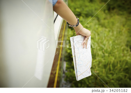 Someone is putting a map out of the train. Someone is putting a map out of the train. 34205182