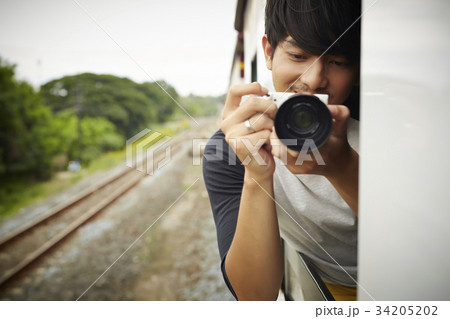 A photographer is reviewing the photo in his camera. A photographer is reviewing the photo in his camera. 34205202