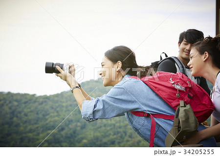 The girl is very interested in taking pictures next to her friends 34205255