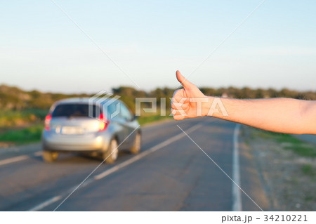 road trip, travel, gesture and people concept - 34210221