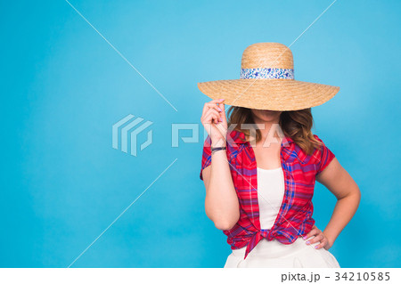 Beautiful graceful woman in elegant hat with a Beautiful graceful woman in elegant hat with a 34210585