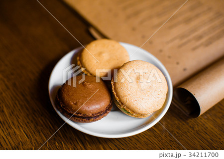The delicious macarons with chocolate, coffee and 34211700