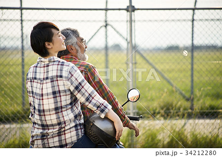 バイクに乗るシニアと女性 34212280