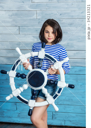 Girl holding a steering wheel Girl holding a steering wheel 34213321