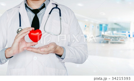 Doctor holding heart on background Doctor holding heart on background 34215393