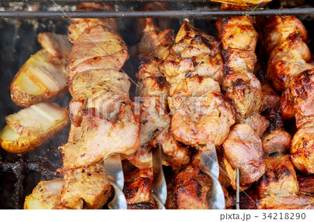 The smoke rises over the fried meat skewers 34218290