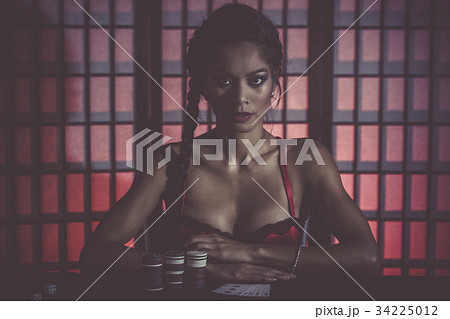 Sexy and happy female poker player 34225012