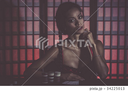 Sexy and happy female poker player 34225013