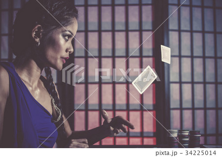 Sexy and happy female poker player 34225014