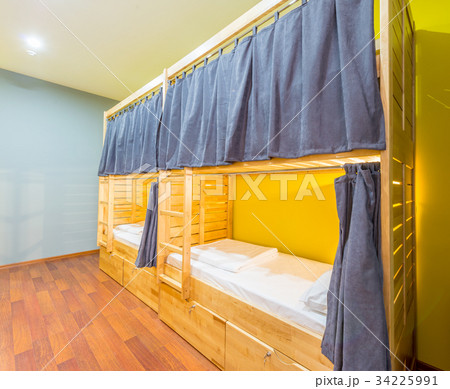 Hostel dormitory beds arranged in room 34225991