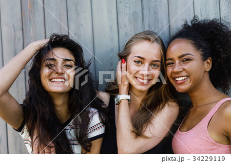 Multiracial female friends having fun outdoors Multiracial female friends having fun outdoors 34229119
