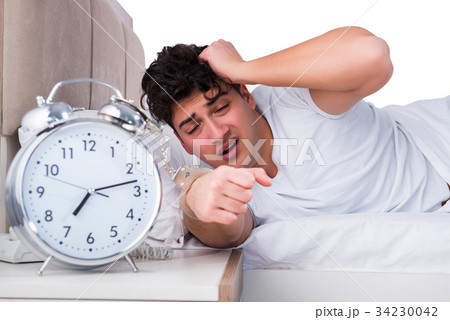 Man in bed suffering from insomnia Man in bed suffering from insomnia 34230042