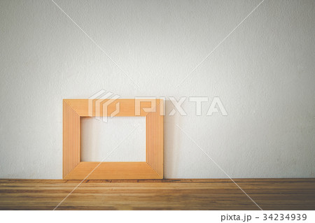 Gold photo frame on wooden 34234939