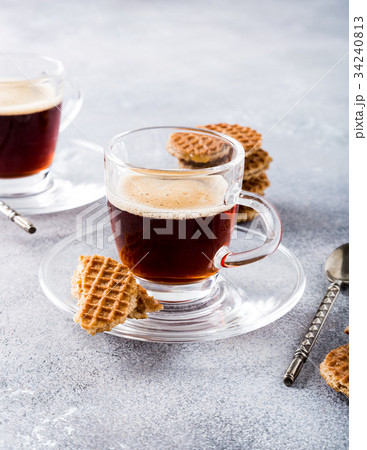 Glass cup of coffee with syrupwaffles cookies Glass cup of coffee with syrupwaffles cookies 34240813