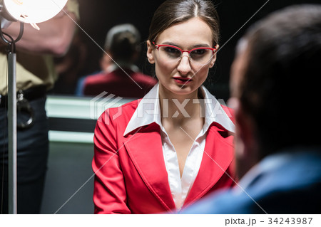 Police detective recording the statement of a Police detective recording the statement of a 34243987