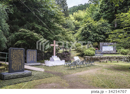 森に囲まれた乙女峠マリア聖堂広場の十字架と石碑 34254707