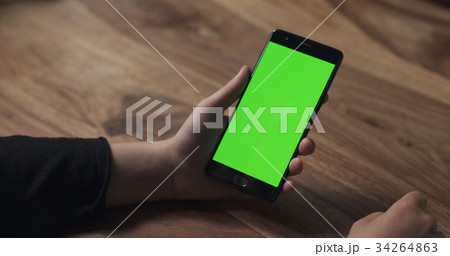 female teen girl hold smartphone with green screen 34264863
