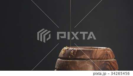 honey drips from dipper in pot honey drips from dipper in pot 34265456