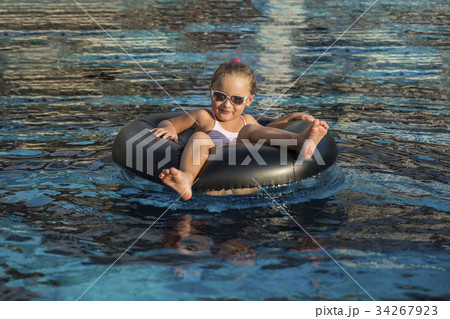 Happy little girl playing with inflatable ring 34267923