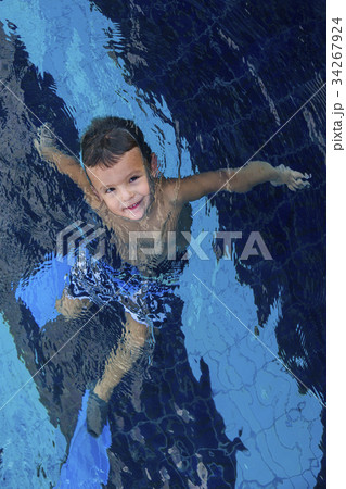 Happy Little child boy swimming in the water 34267924